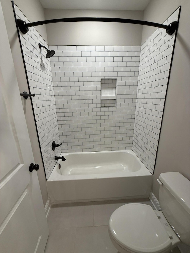 bathroom featuring tile patterned floors, toilet, and bathtub / shower combination