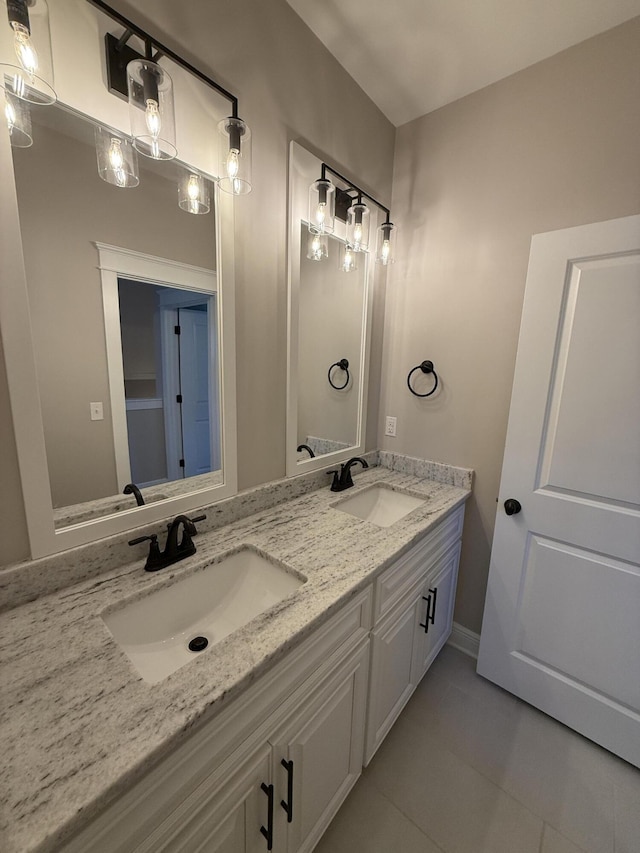 bathroom featuring tile patterned flooring, double vanity, and a sink