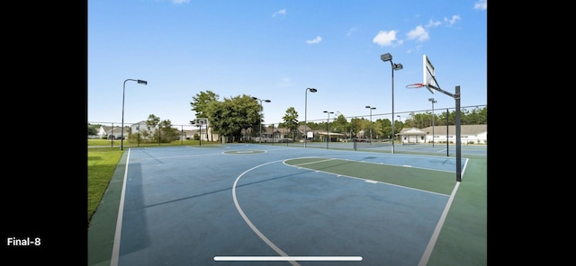 view of basketball court with community basketball court and fence