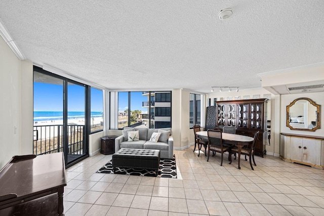 9850 S Thomas Dr Unit 205W, Panama City Beach, FL 32408 - living room with baseboards, a textured ceiling, light tile patterned flooring, and track lighting