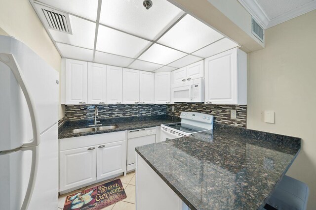 9850 S Thomas Dr Unit 205W, Panama City Beach, FL 32408 - kitchen featuring visible vents, a sink, white appliances, a peninsula, and white cabinets