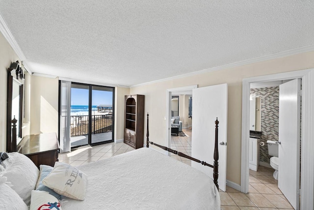 9850 S Thomas Dr Unit 205W, Panama City Beach, FL 32408 - bedroom featuring baseboards, light tile patterned flooring, ornamental molding, a textured ceiling, and access to outside