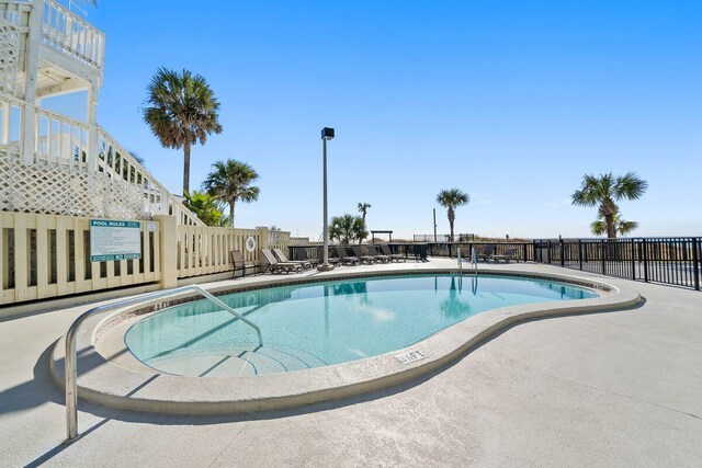 9850 S Thomas Dr Unit 205W, Panama City Beach, FL 32408 - pool featuring stairway, a patio, and fence