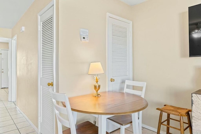 dining room with light tile patterned floors and baseboards