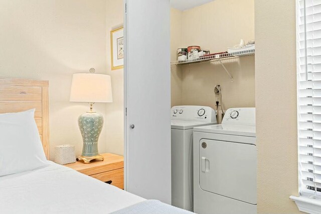 clothes washing area with washer and dryer and laundry area