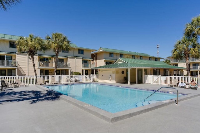 pool featuring a patio and fence