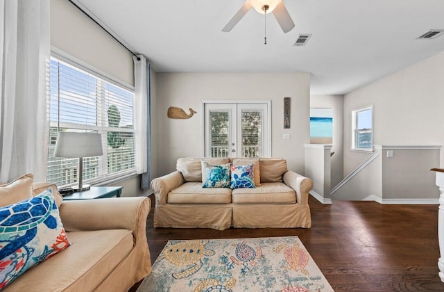 living room with visible vents, wood finished floors, and a healthy amount of sunlight