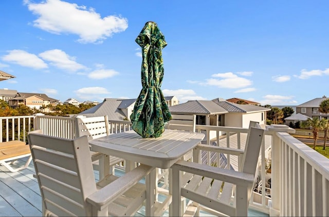 deck with a residential view and outdoor dining area
