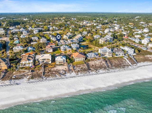 aerial view featuring a beach view, a water view, and a residential view