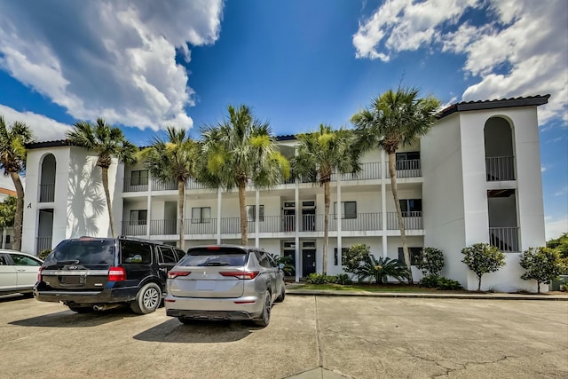 view of building exterior with uncovered parking