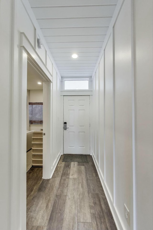 corridor featuring dark wood-style flooring