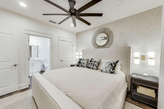 bedroom with recessed lighting, ensuite bath, visible vents, a ceiling fan, and wood finished floors