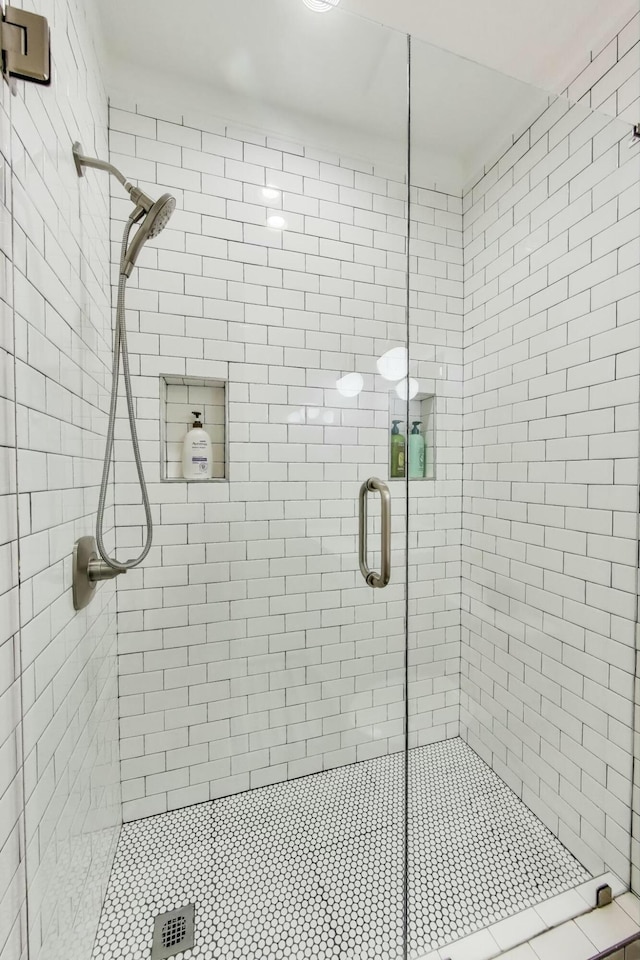full bath featuring a shower stall
