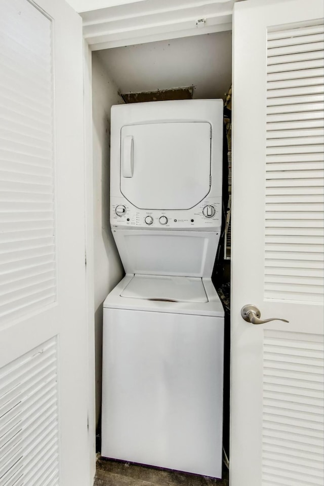 laundry area with laundry area and stacked washer / drying machine