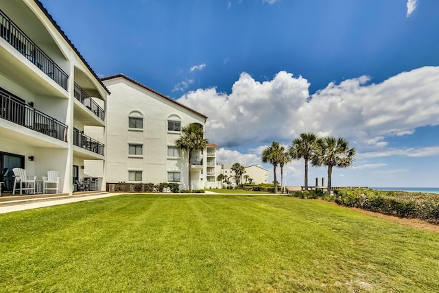 surrounding community featuring a water view and a yard