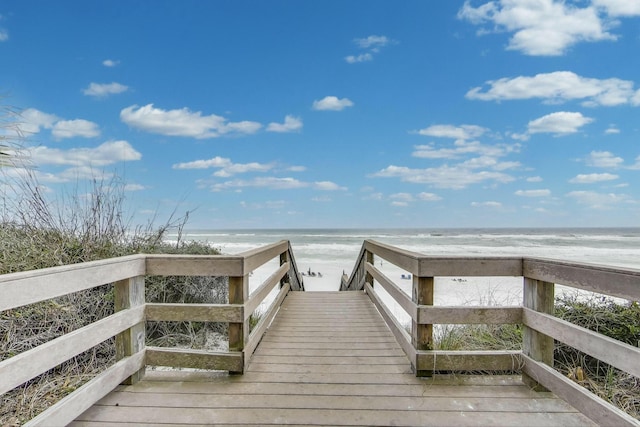 surrounding community featuring a view of the beach and a water view