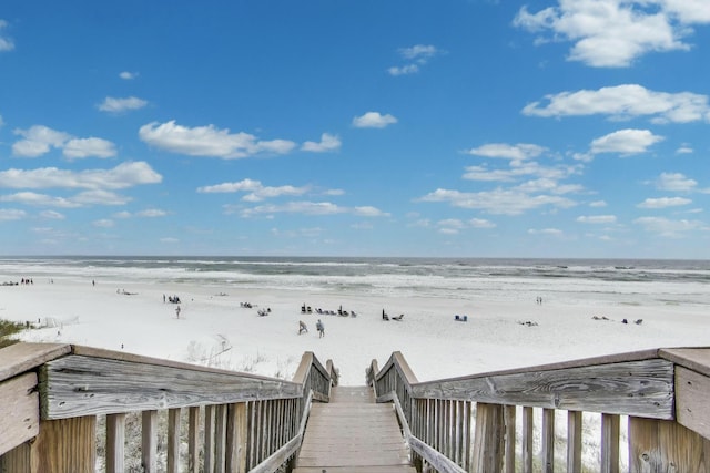 view of property's community with a beach view and a water view