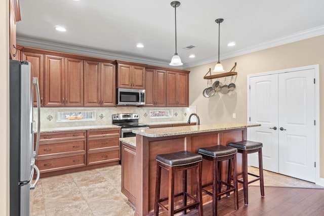 kitchen with light stone counters, decorative backsplash, stainless steel appliances, a kitchen bar, and ornamental molding