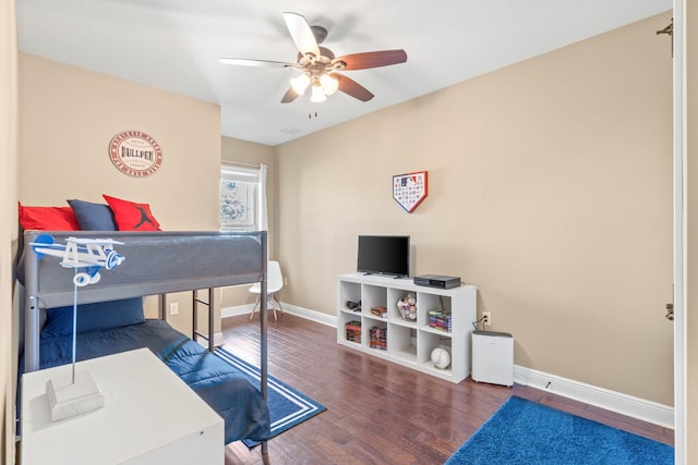 bedroom featuring wood finished floors, ceiling fan, and baseboards