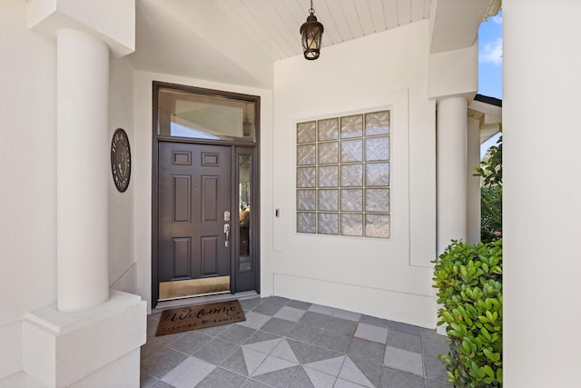 doorway to property featuring stucco siding