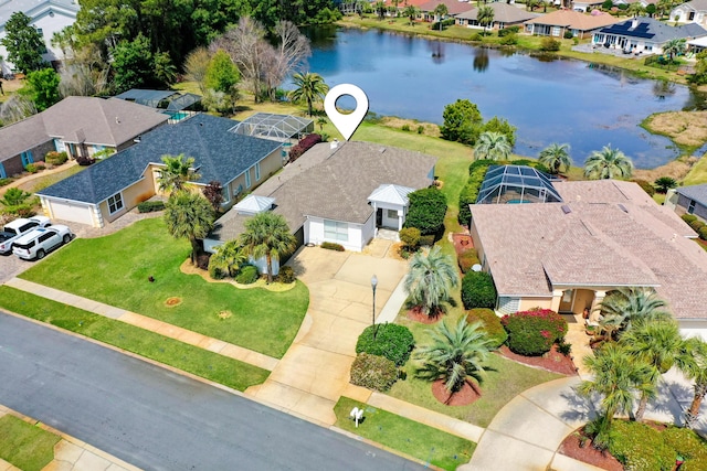 birds eye view of property featuring a water view and a residential view