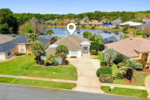 birds eye view of property with a water view and a residential view