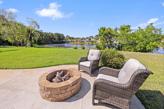 view of patio / terrace featuring a water view and a fire pit