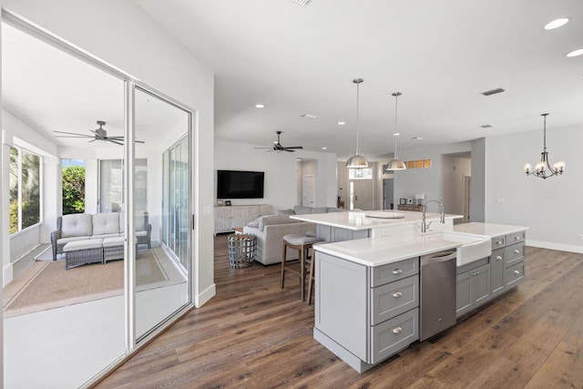 kitchen featuring open floor plan, ceiling fan with notable chandelier, and gray cabinets