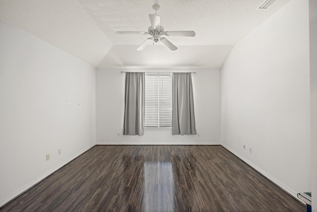 unfurnished room with a textured ceiling, a baseboard heating unit, wood finished floors, and lofted ceiling