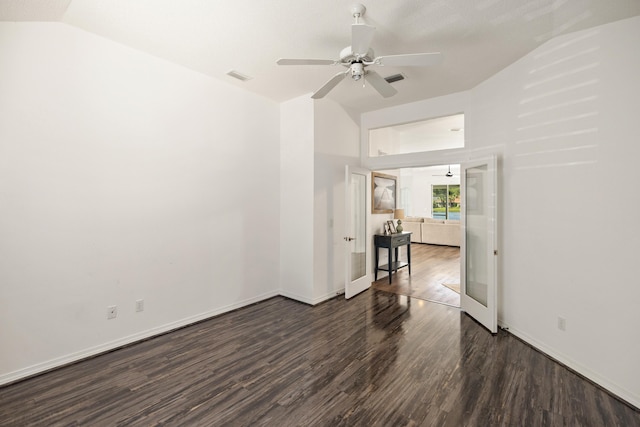 spare room with baseboards, vaulted ceiling, a ceiling fan, visible vents, and wood finished floors
