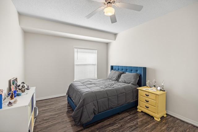 bedroom with dark wood-type flooring, a textured ceiling, and baseboards