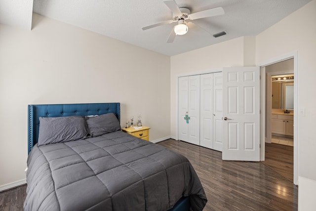 bedroom featuring ceiling fan, a closet, visible vents, wood finished floors, and baseboards