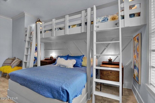 8320 Surf Dr, Panama City Beach, FL 32408 - bedroom with visible vents, wood finished floors, and ornamental molding