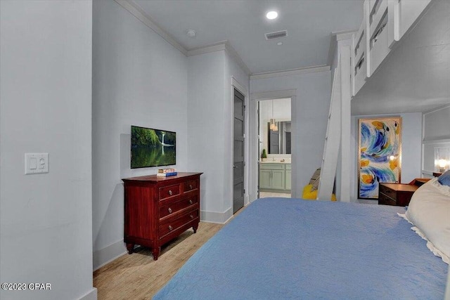 8320 Surf Dr, Panama City Beach, FL 32408 - bedroom with baseboards, visible vents, light wood finished floors, ornamental molding, and ensuite bathroom