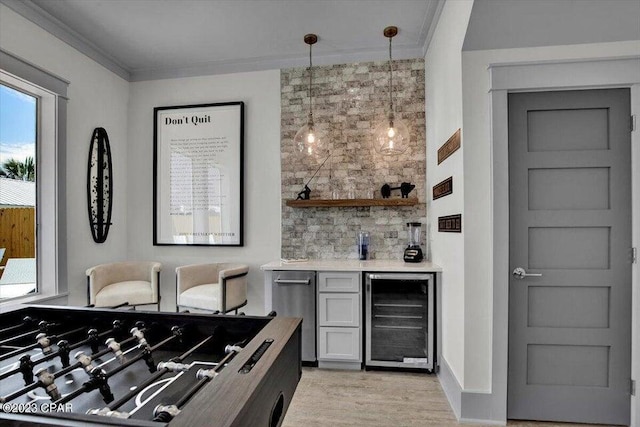 8320 Surf Dr, Panama City Beach, FL 32408 - bar featuring crown molding, wine cooler, light wood-style floors, hanging light fixtures, and a bar