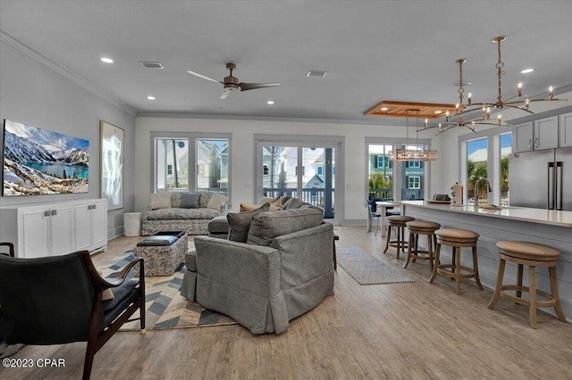8320 Surf Dr, Panama City Beach, FL 32408 - living room with plenty of natural light, light wood-style floors, and ornamental molding