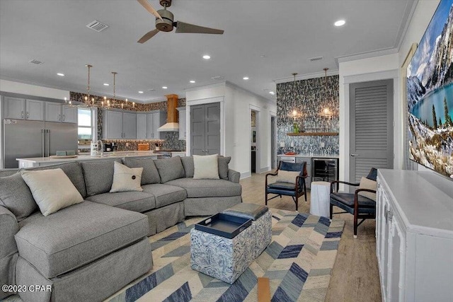 8320 Surf Dr, Panama City Beach, FL 32408 - living room with recessed lighting, visible vents, ornamental molding, and ceiling fan with notable chandelier