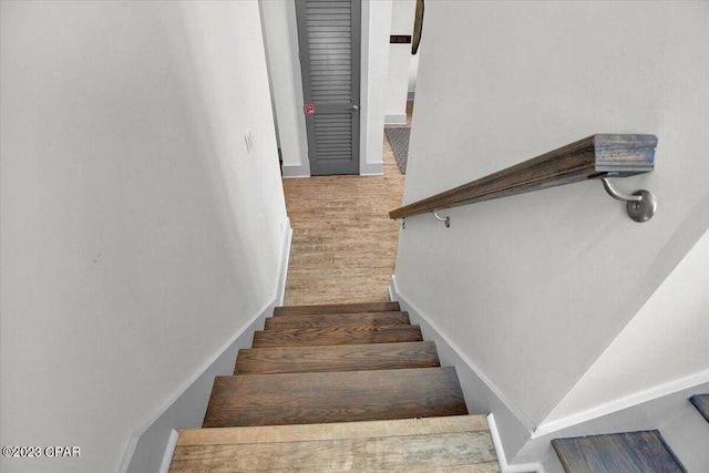 8320 Surf Dr, Panama City Beach, FL 32408 - stairway featuring wood finished floors