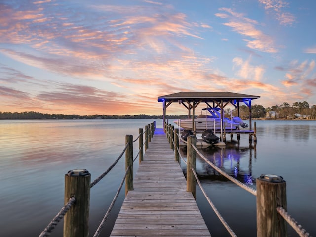 view of dock with boat lift and a water view