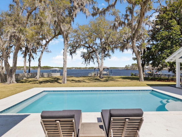 view of pool featuring a lawn, a water view, fence, and a fenced in pool
