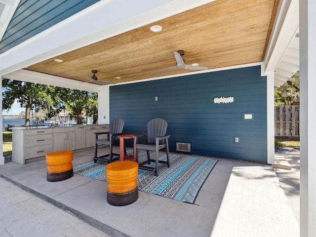 view of patio / terrace with fence, visible vents, and ceiling fan
