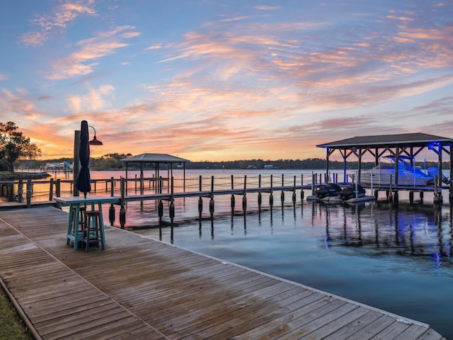 view of dock with boat lift and a water view