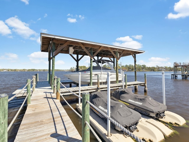 dock area featuring boat lift and a water view