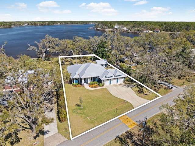 aerial view with a water view and a forest view