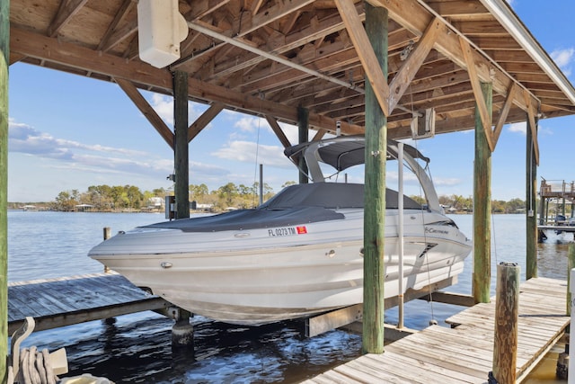 view of dock featuring boat lift and a water view