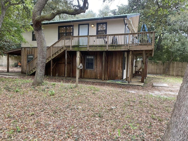3139 Live Oak St, Navarre, FL 32566 - rear view of house with fence, stairway, and a deck