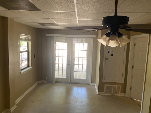 3139 Live Oak St, Navarre, FL 32566 - interior space featuring ceiling fan, a paneled ceiling, baseboards, finished concrete floors, and visible vents