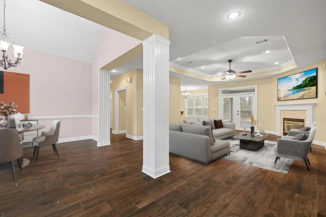 2824 Pear Orchard Blvd, Crestview, FL 32539 - living area featuring a tray ceiling, wood finished floors, visible vents, baseboards, and ceiling fan with notable chandelier