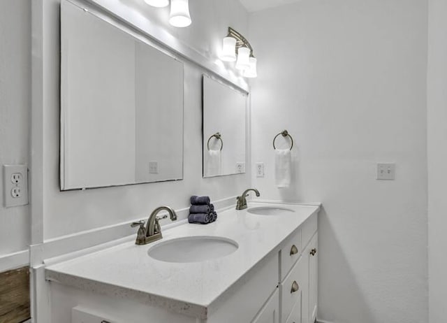 bathroom featuring double vanity and a sink