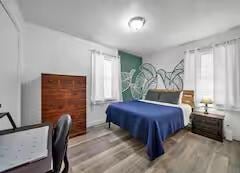 bedroom with wood finished floors